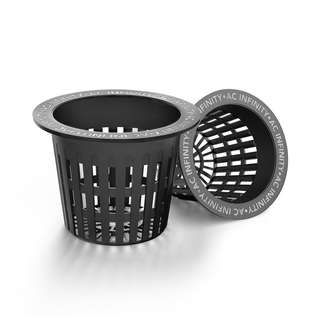 Black perforated cylindrical trash bin with a matching tipped-over bin on a white background