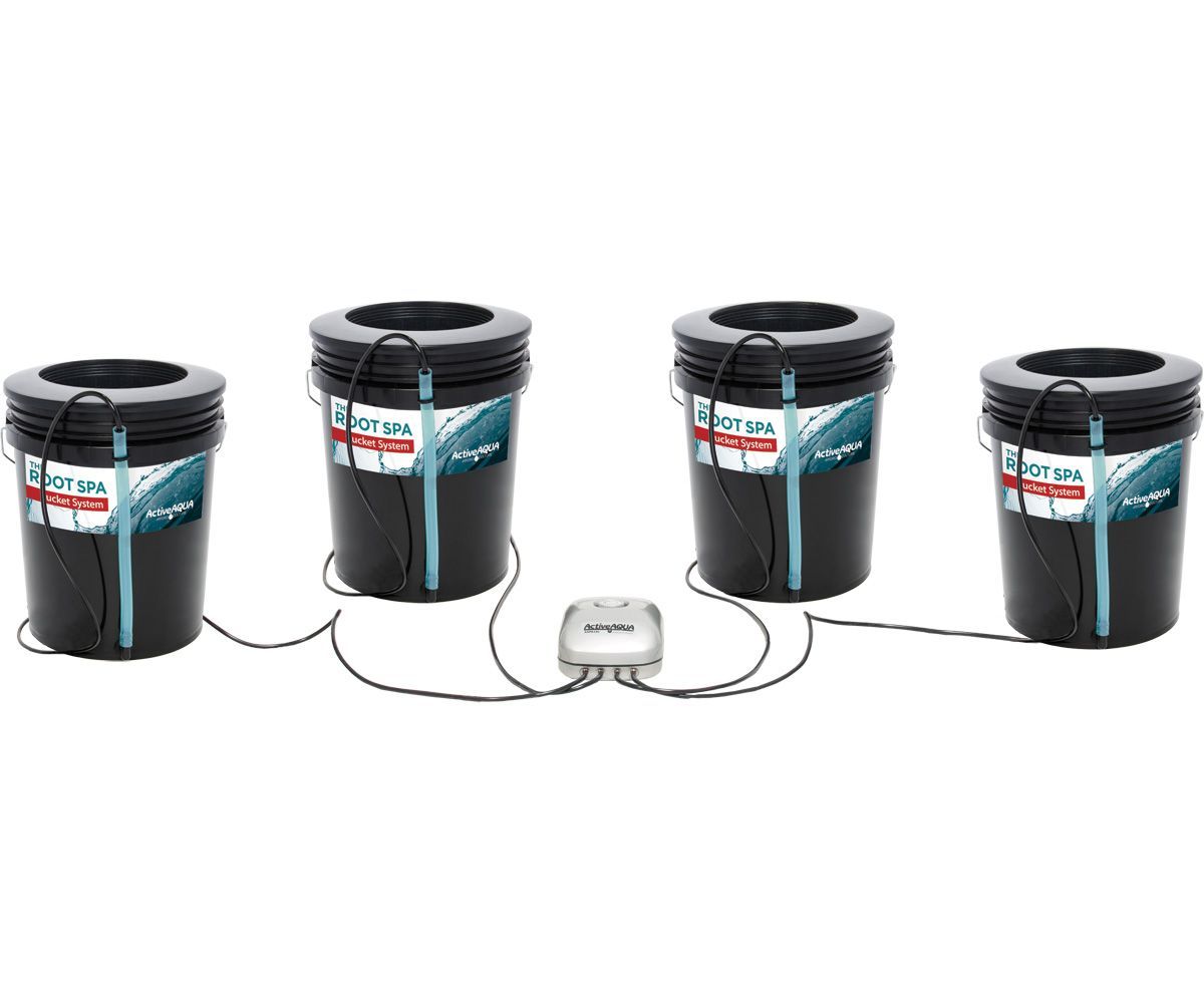 Four black water filter canisters connected by tubing to a central control unit on a white background