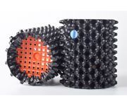 Two black spiky rollers with orange perforated ends on a white background