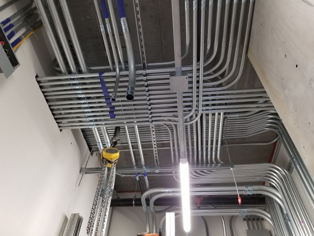 A room with a lot of pipes hanging from the ceiling