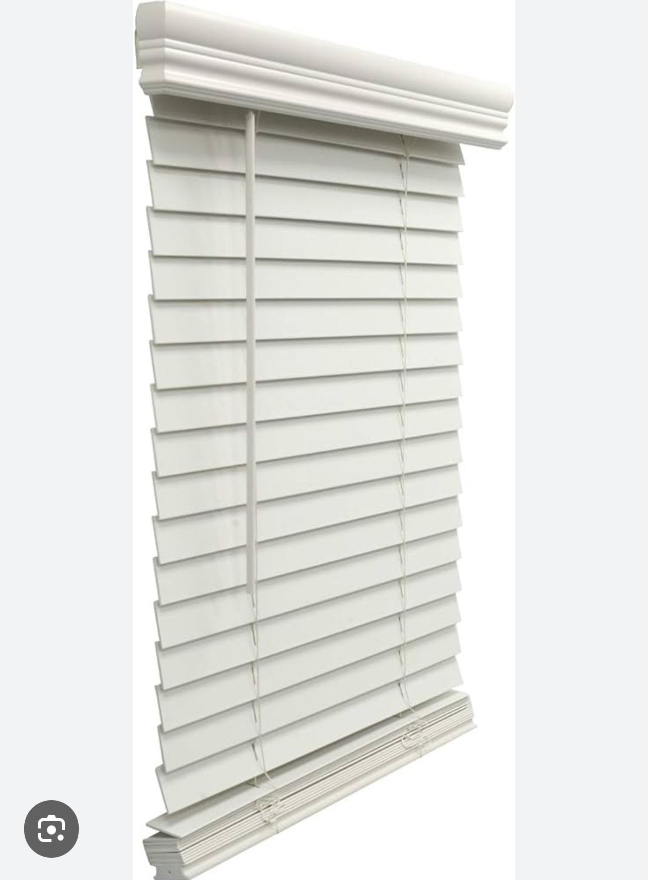 A white wooden blind is hanging on a window.