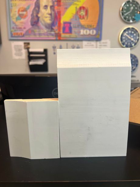 A 100 dollar bill is behind two white blocks