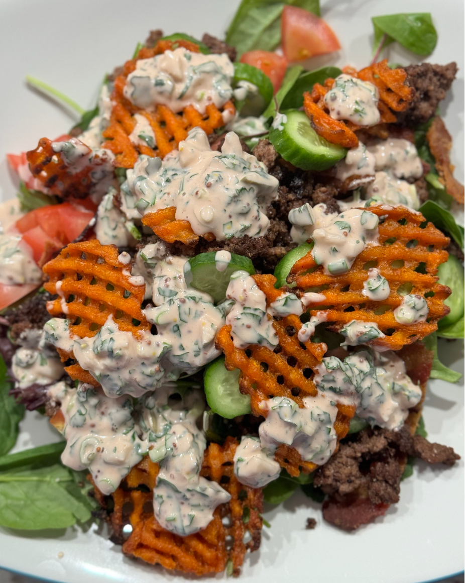 Photo of beef burger salad with cucumber, sweet potato fries and 