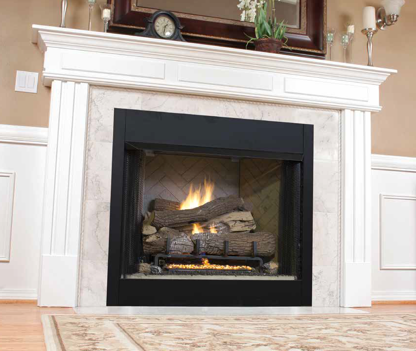 A lit gas fireplace with a black metal surround, set in a white wood mantel with marble tile and a clock on the shelf.