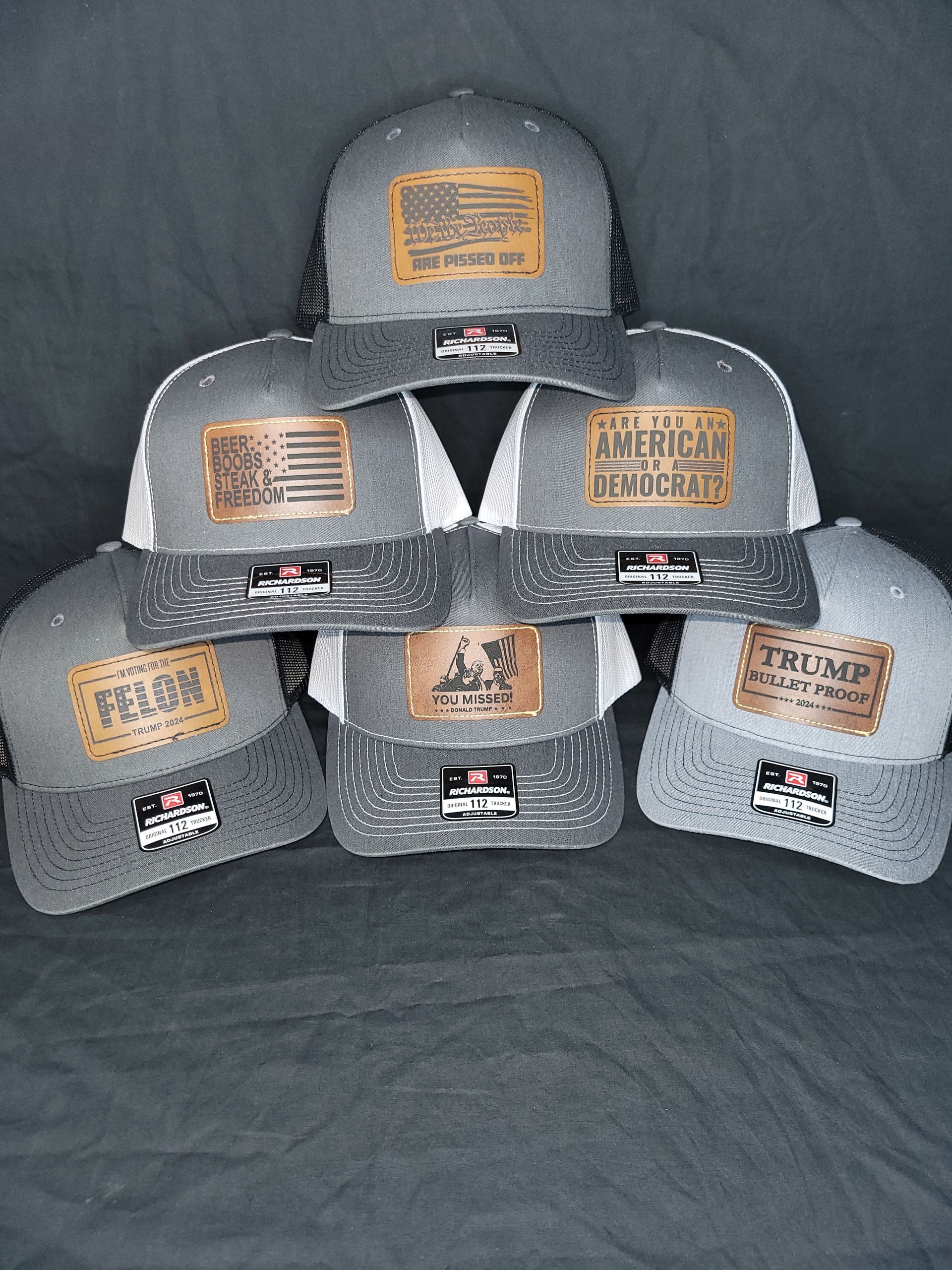 A group of hats are stacked on top of each other on a table.