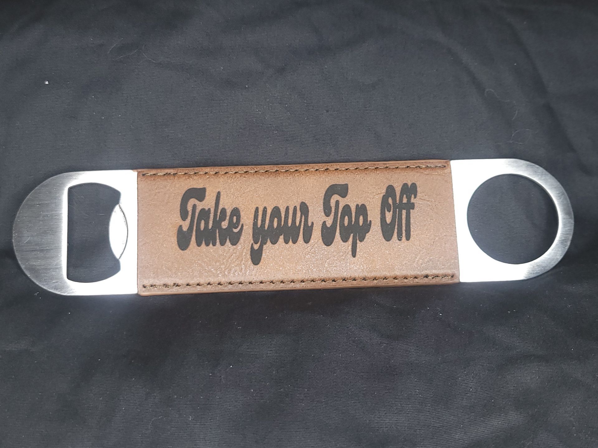 A bottle opener that says take your top off
