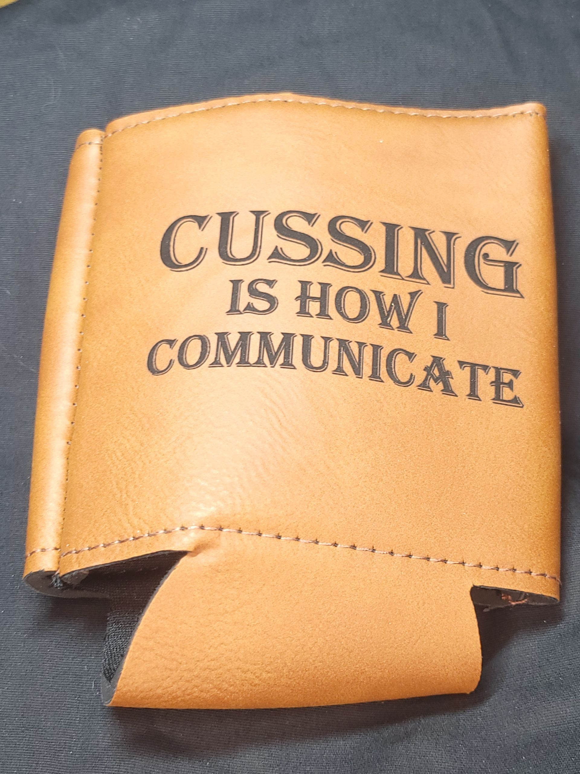 A brown book that says cussing is how i communicate