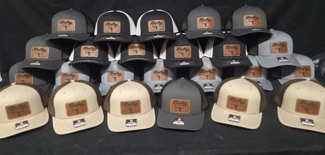 A bunch of hats are lined up on a table.