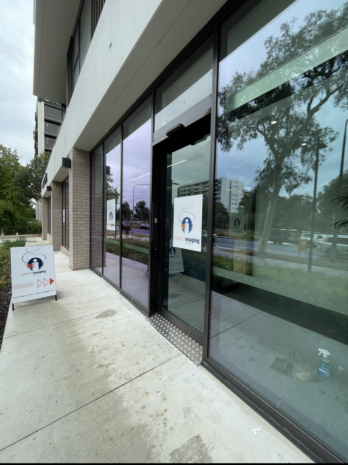 A building with a lot of windows and a sign in front of it.