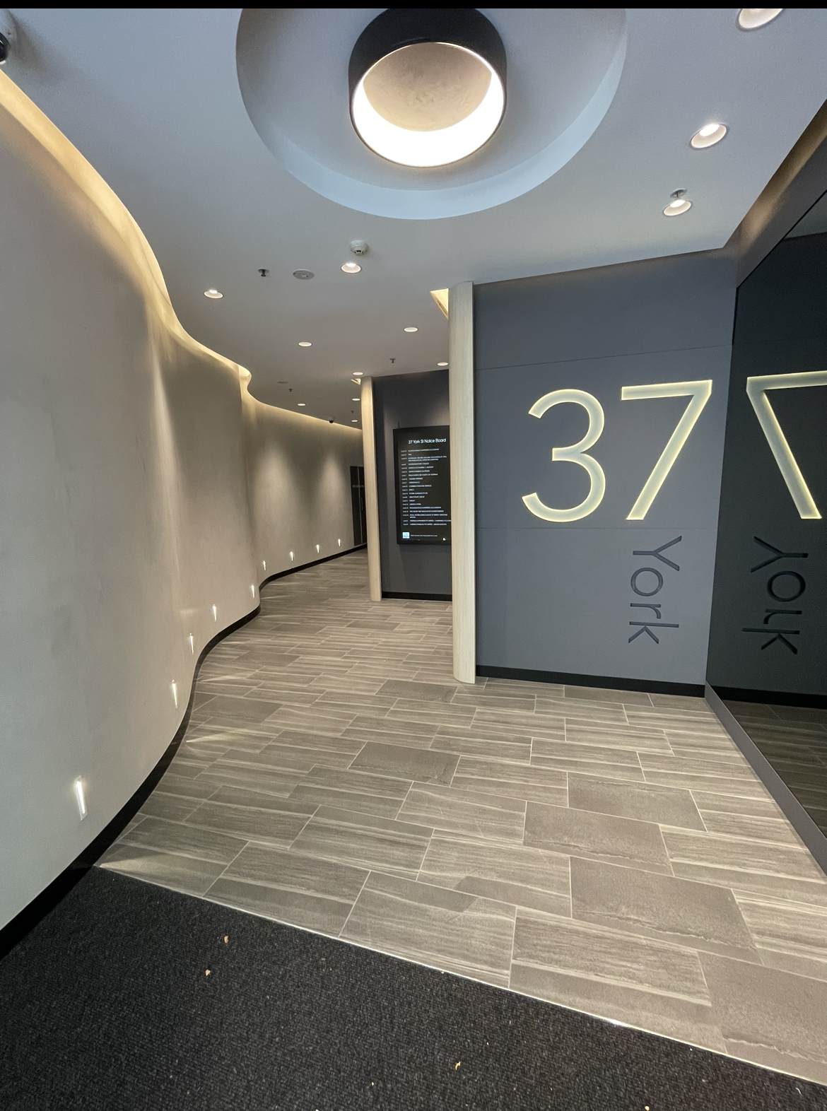 A hallway with a sign on the wall that says 37 on it.