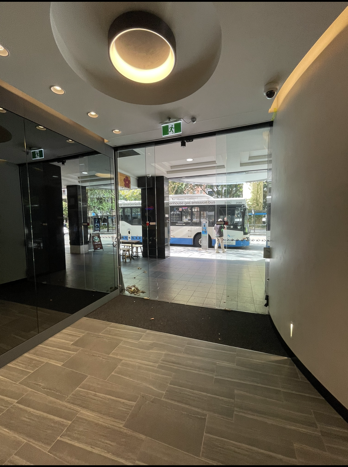 A large lobby with a lot of windows and a ceiling light.