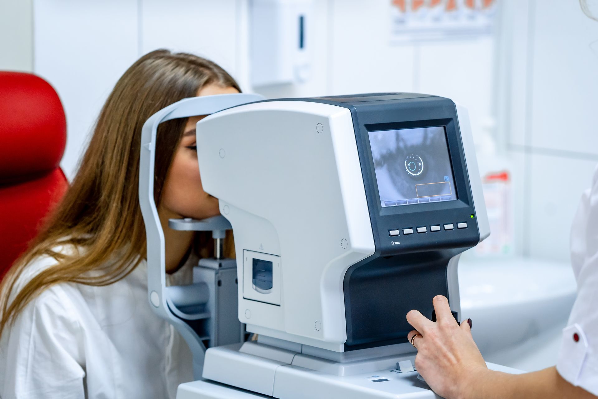 Person using an eye exam machine in a bright clinic