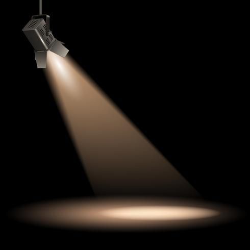 Spotlight illuminating a dark space; light is directed downward, creating a circular pool of light below.
