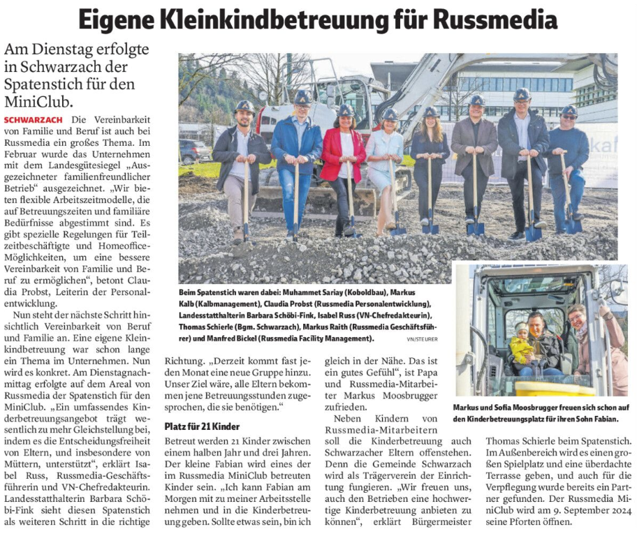 Eine Gruppe von Menschen steht nebeneinander und hält Schaufeln in einer Zeitung.