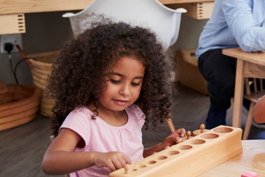 Child working with Montessori materials