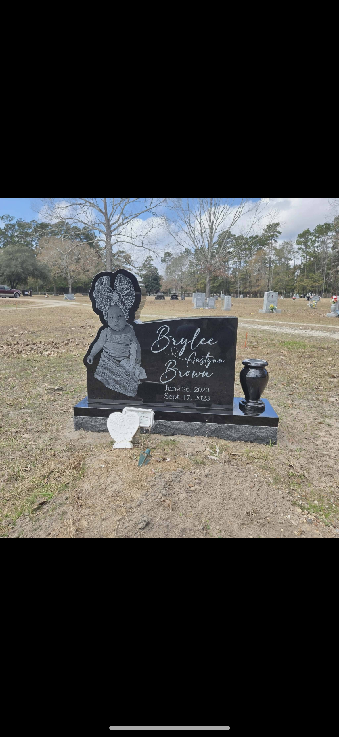 A gravestone for bruce betty j. b. is in a cemetery.