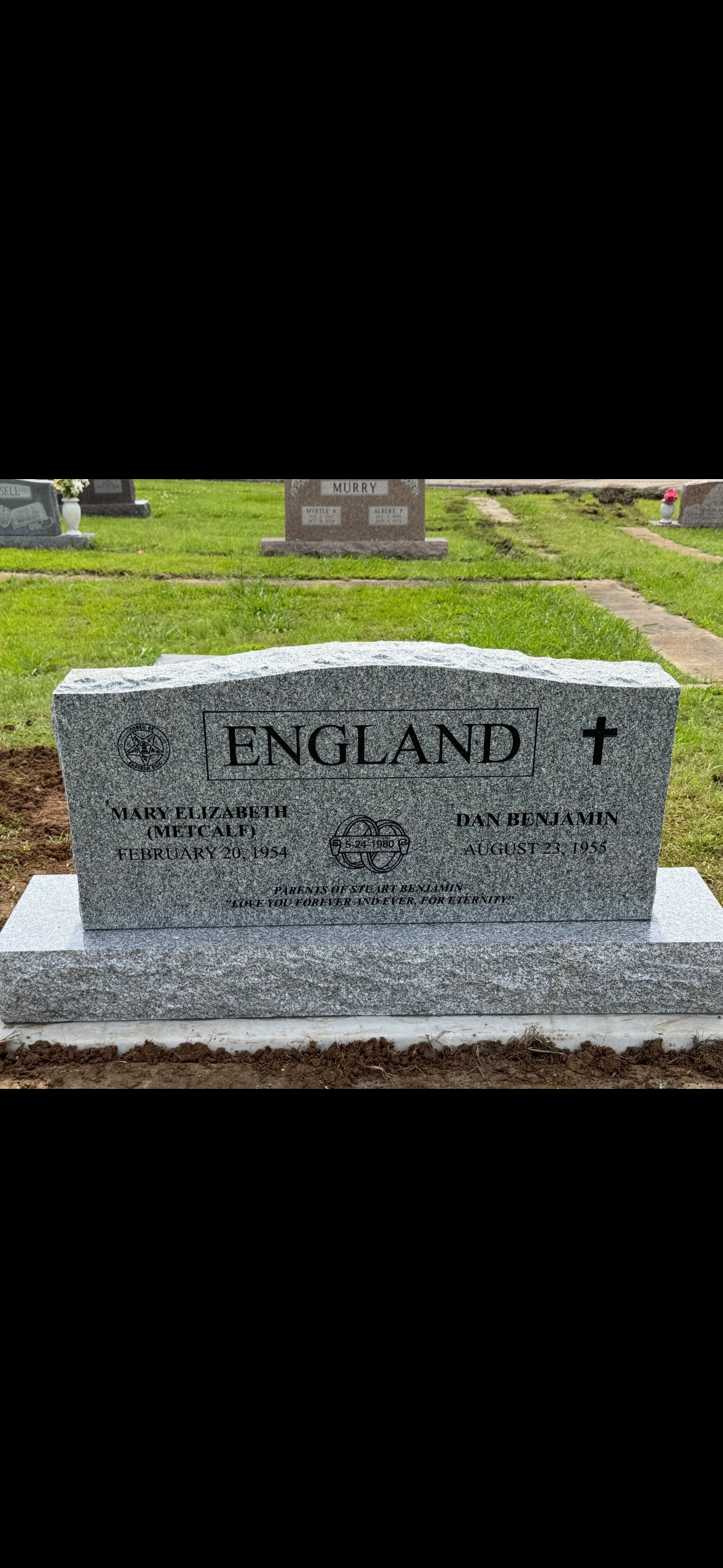 A gravestone for seldon protiro is sitting in the dirt.