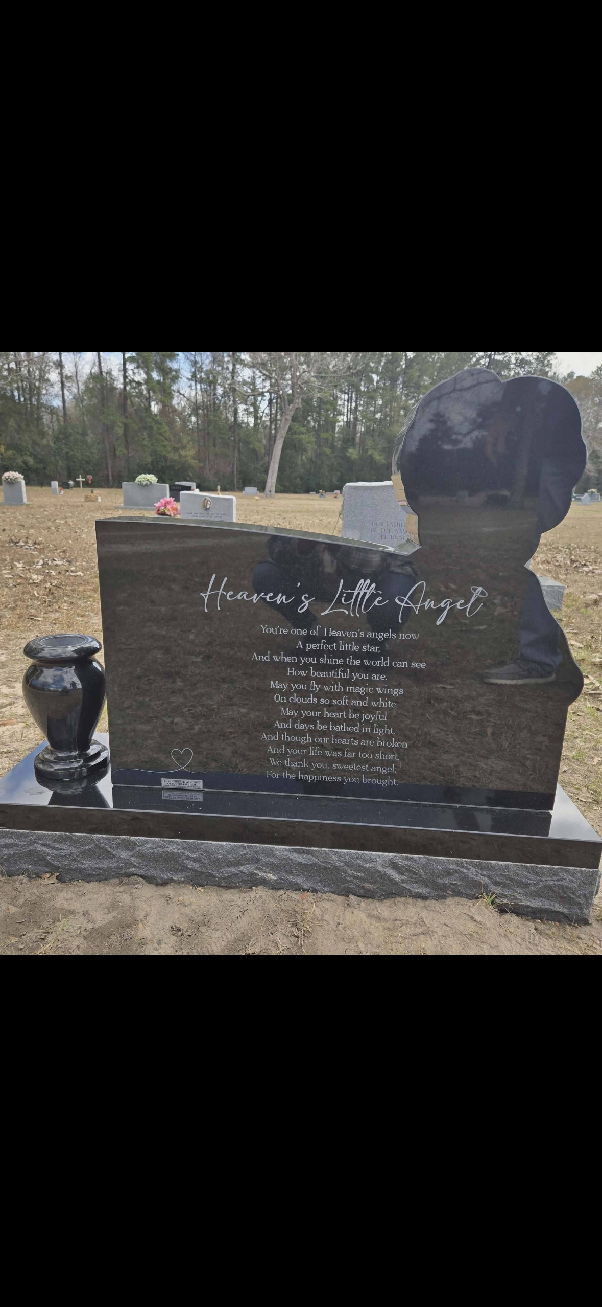 A gravestone for jasmine rose camacho is surrounded by flowers