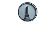 Circular blue-gray icon featuring a black obelisk or monument silhouette in the center.