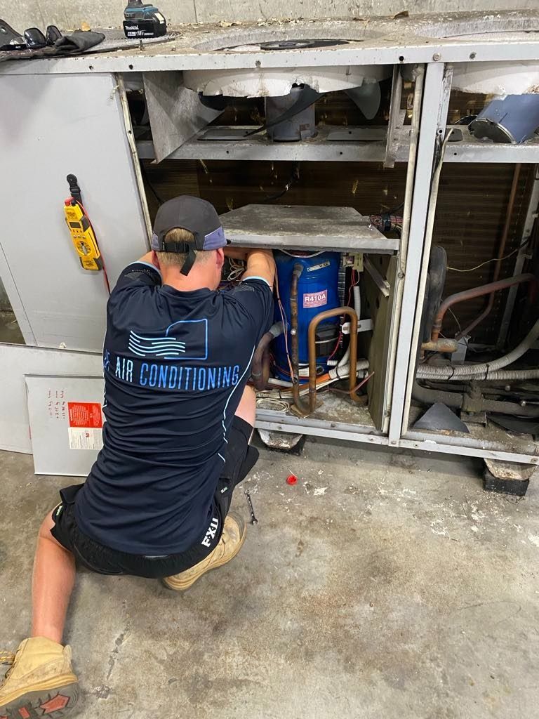 A Technician Repairing an Industrial Air Conditioning Unit — JF Air Conditioning Pty Ltd in Lake Macquarie, NSW
