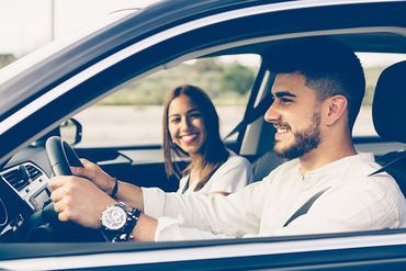 Happy Young Man Driving A Car — Chicago, IL — Clover Insurance Agency Happy Young Man Driving A Car — Chicago, IL — Clover Insurance Agency