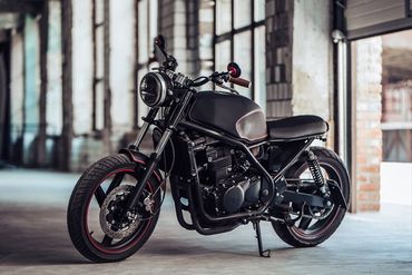 Modern Black Motorcycle In Garage — Chicago, IL — Clover Insurance Agency Modern Black Motorcycle In Garage — Chicago, IL — Clover Insurance Agency
