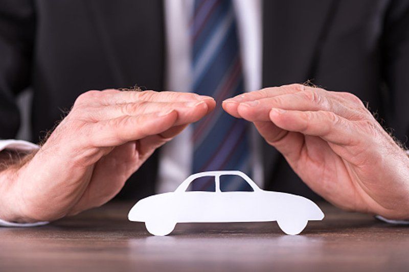 Car Insurance With Hands Over A Car — Chicago, IL — Clover Insurance Agency