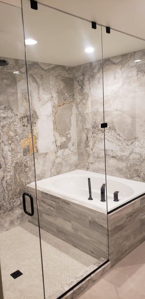 A bathroom with a bathtub and a walk in shower.