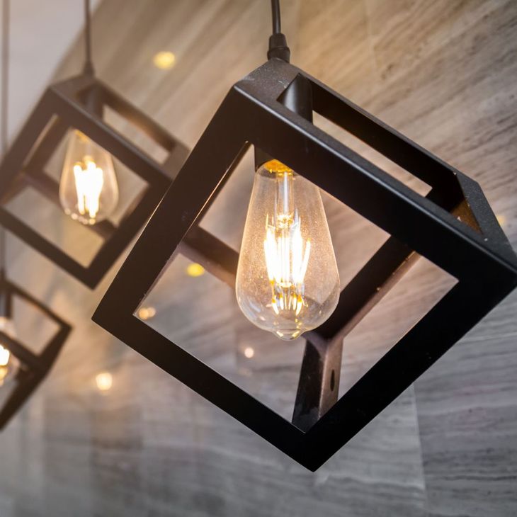 A row of square pendant lights hanging from the ceiling