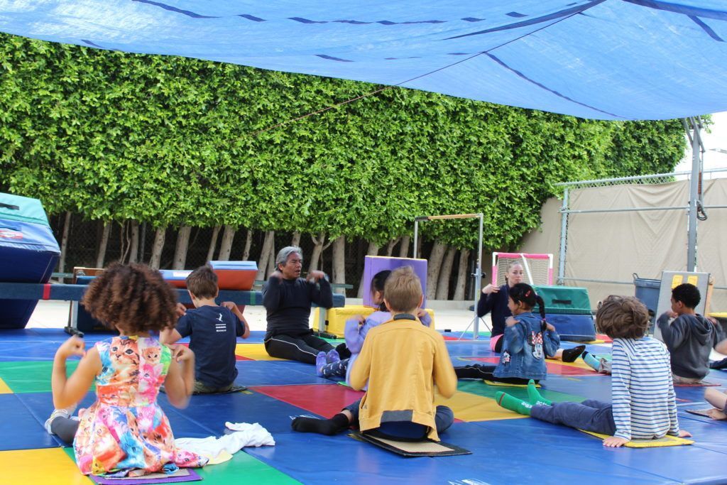 Montessori guide and children during outdoors activities