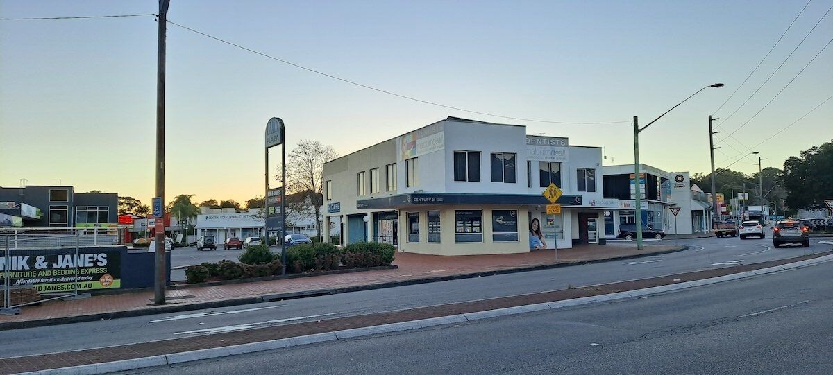 A Street With A Building In The Background — Mark's Flooring & Handyman Services In Erina, NSW