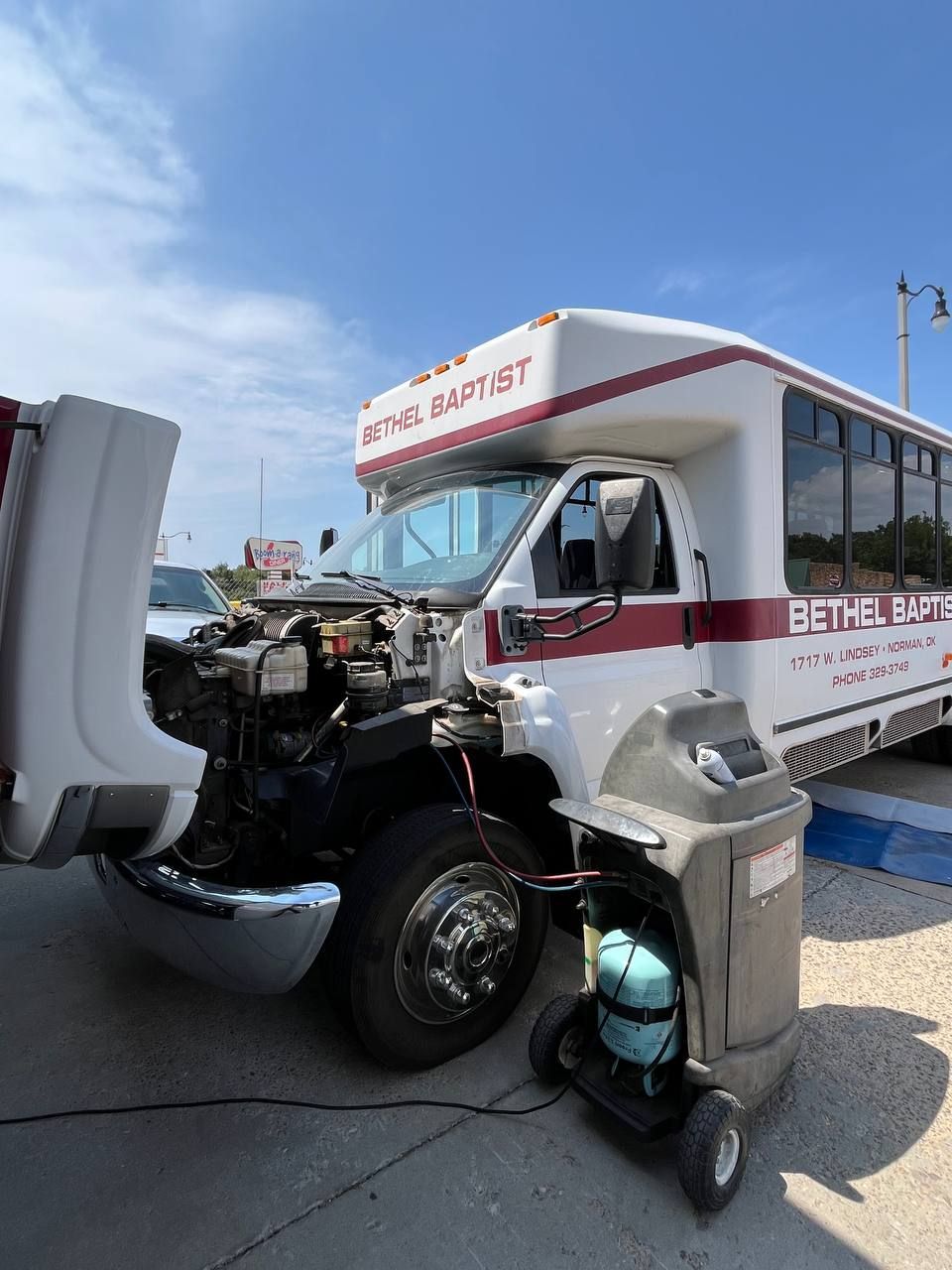 2007 GMC C5500 TopKick shuttle bus undergoing A/C diagnosis and service in Norman, Oklahoma