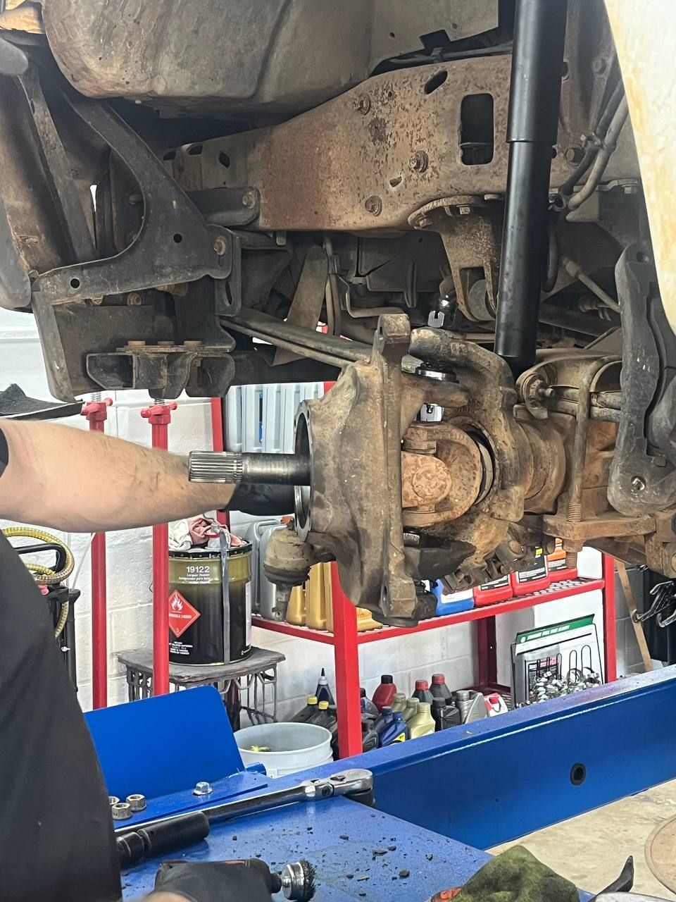 A closer look at the steering knuckle and ball joint area during the F-250 front-end repair.