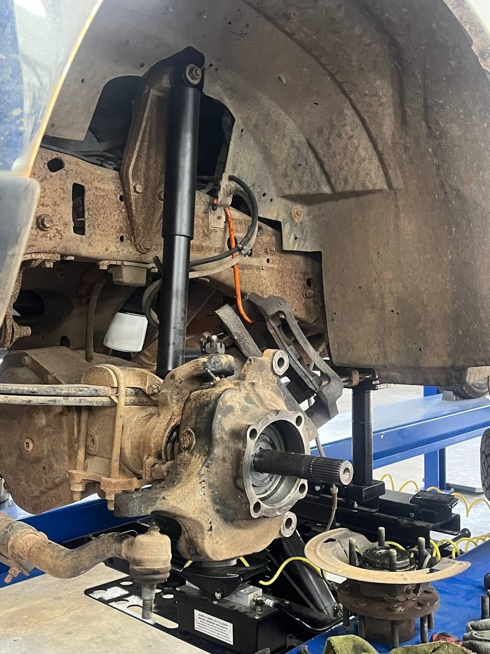 Front suspension disassembled to access the upper and lower ball joints on the Ford F-250 Super Duty.
