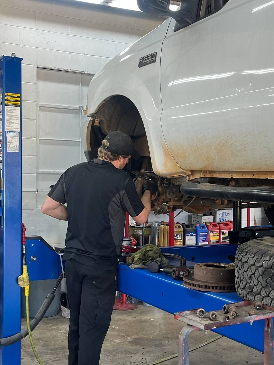 Our technician working on the front suspension of this Ford F-250 during ball joint and shock replacement.