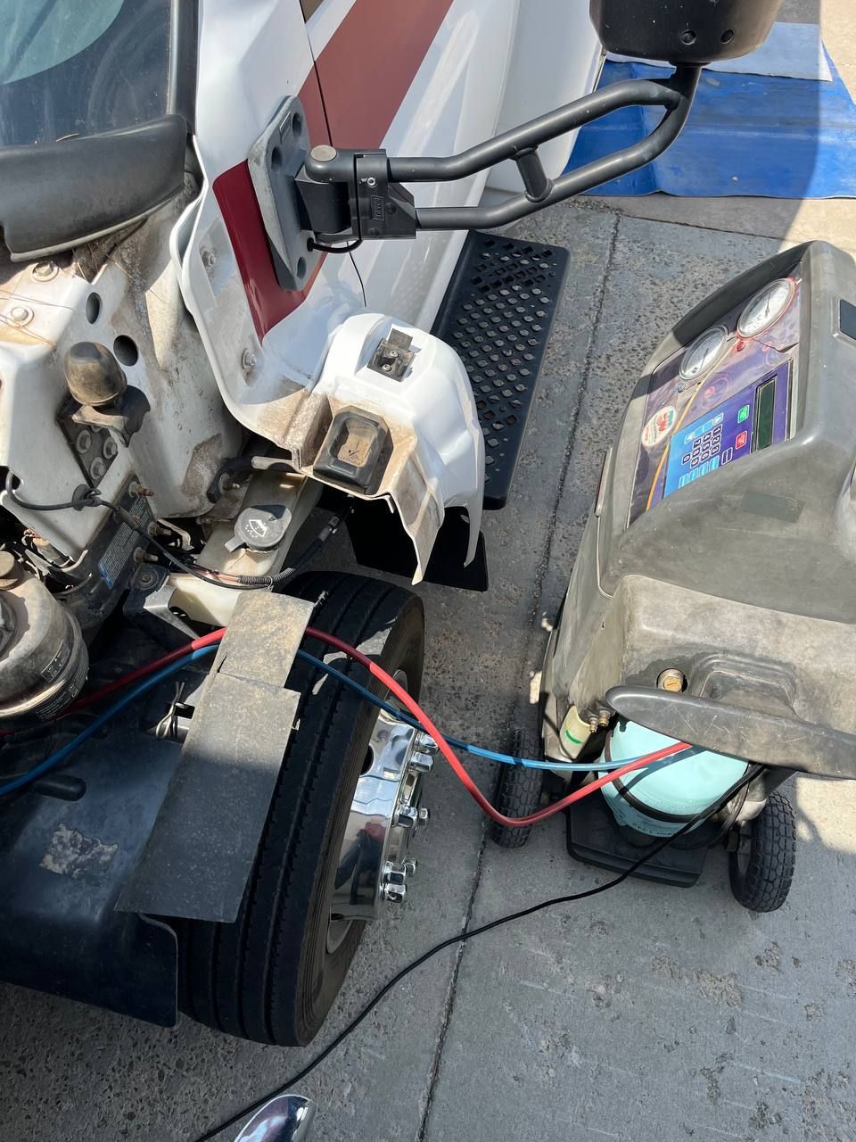A/C service equipment connected to a GMC C5500 TopKick shuttle bus in Norman Oklahoma