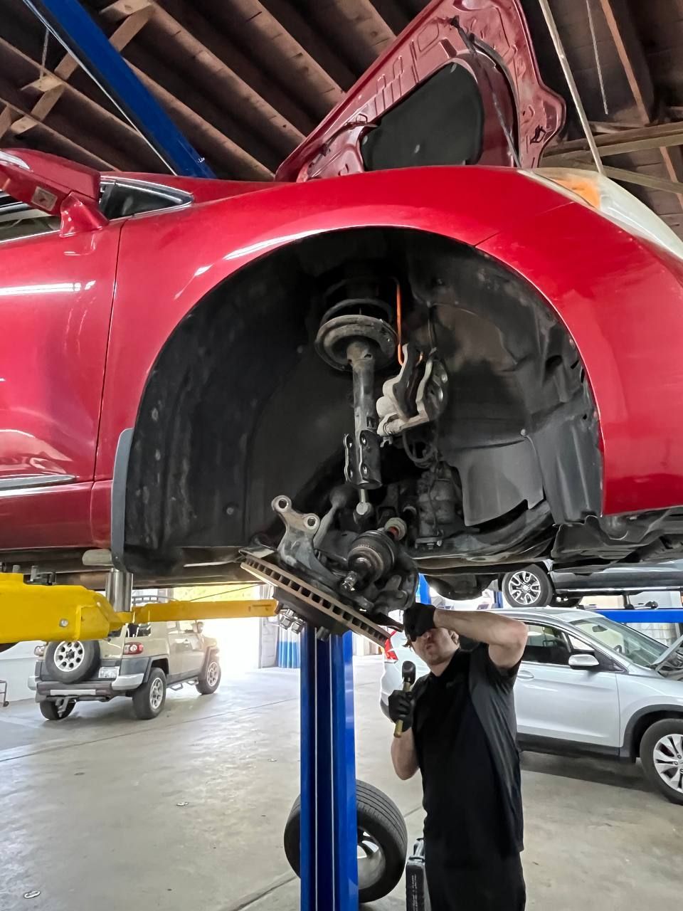 Technician repairing Toyota Venza front wheel end