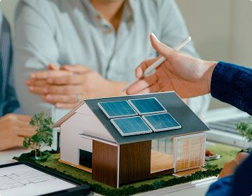 Couple with advisor going over installing a solar panel