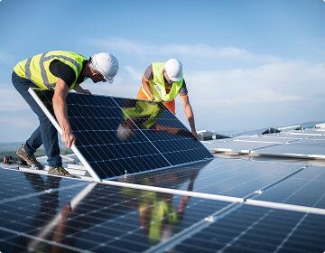 Workers installing solar panel