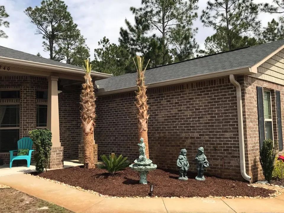 A brick house with a blue chair in front of it