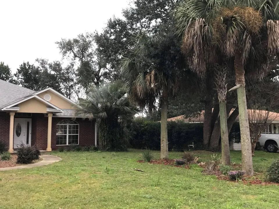 A brick house with a white truck parked in front of it