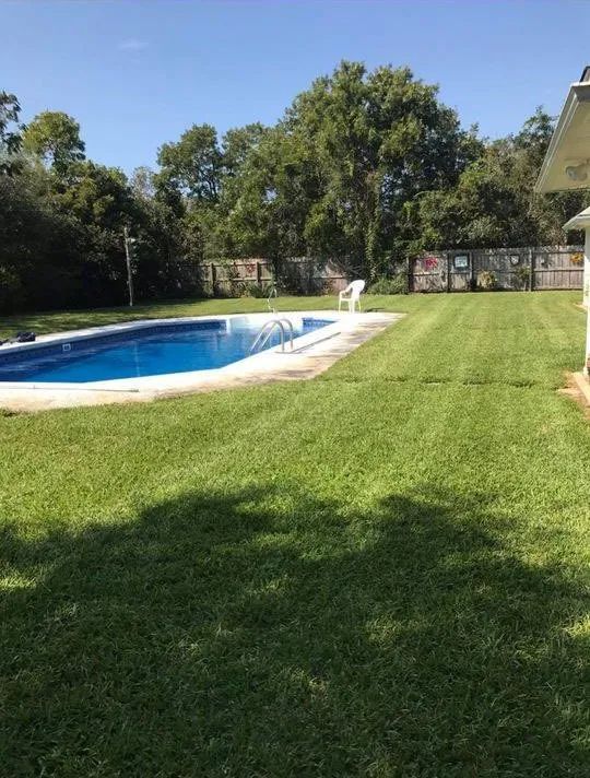 A large swimming pool in the backyard of a house