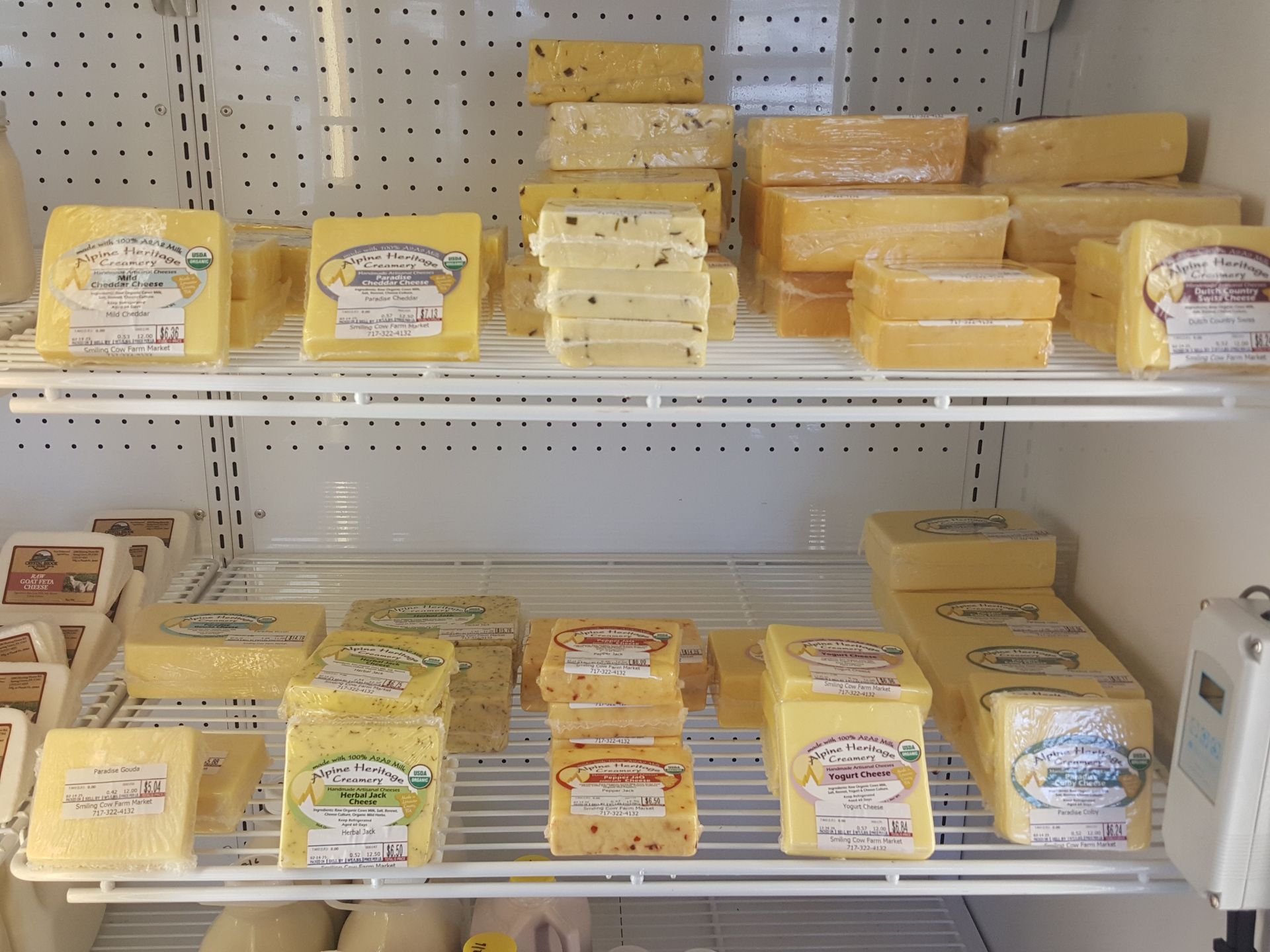A refrigerator filled with different types of cheese