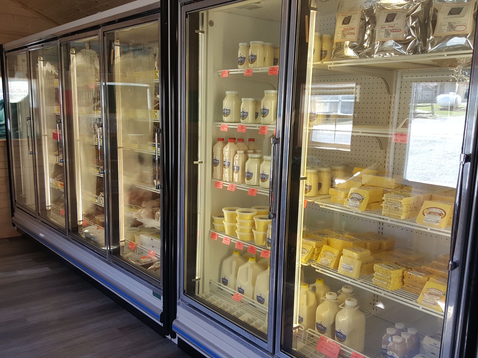 A refrigerator filled with lots of milk and cheese.