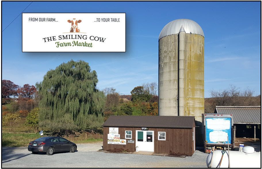A car is parked in front of the smiling cow farm market