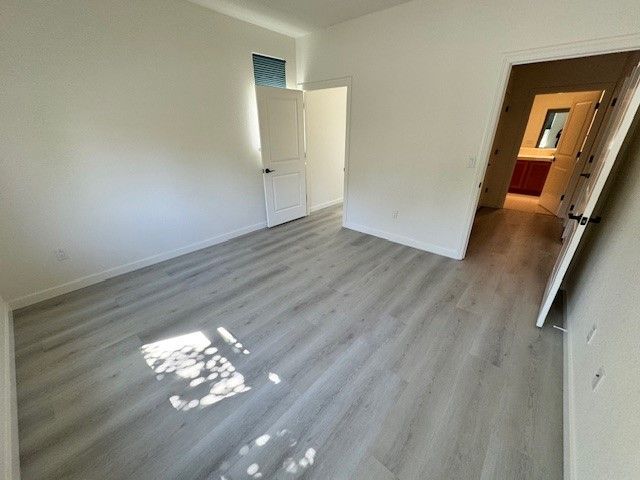 A room with hardwood floors and white walls