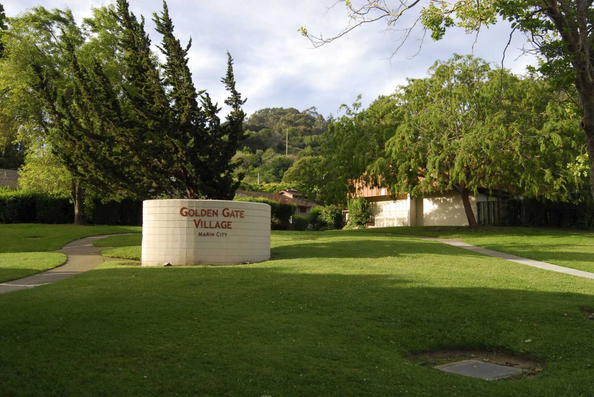 A sign in a grassy area says geneva glen village