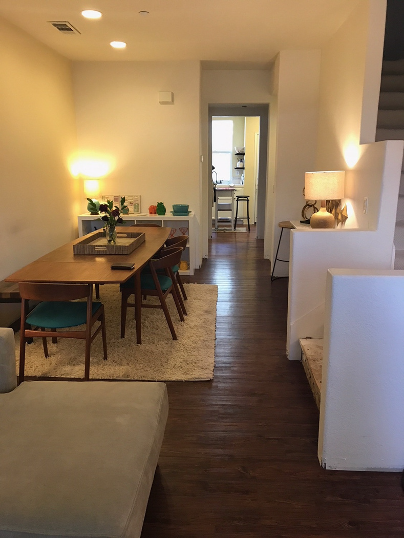 A living room with a table and chairs and a couch.