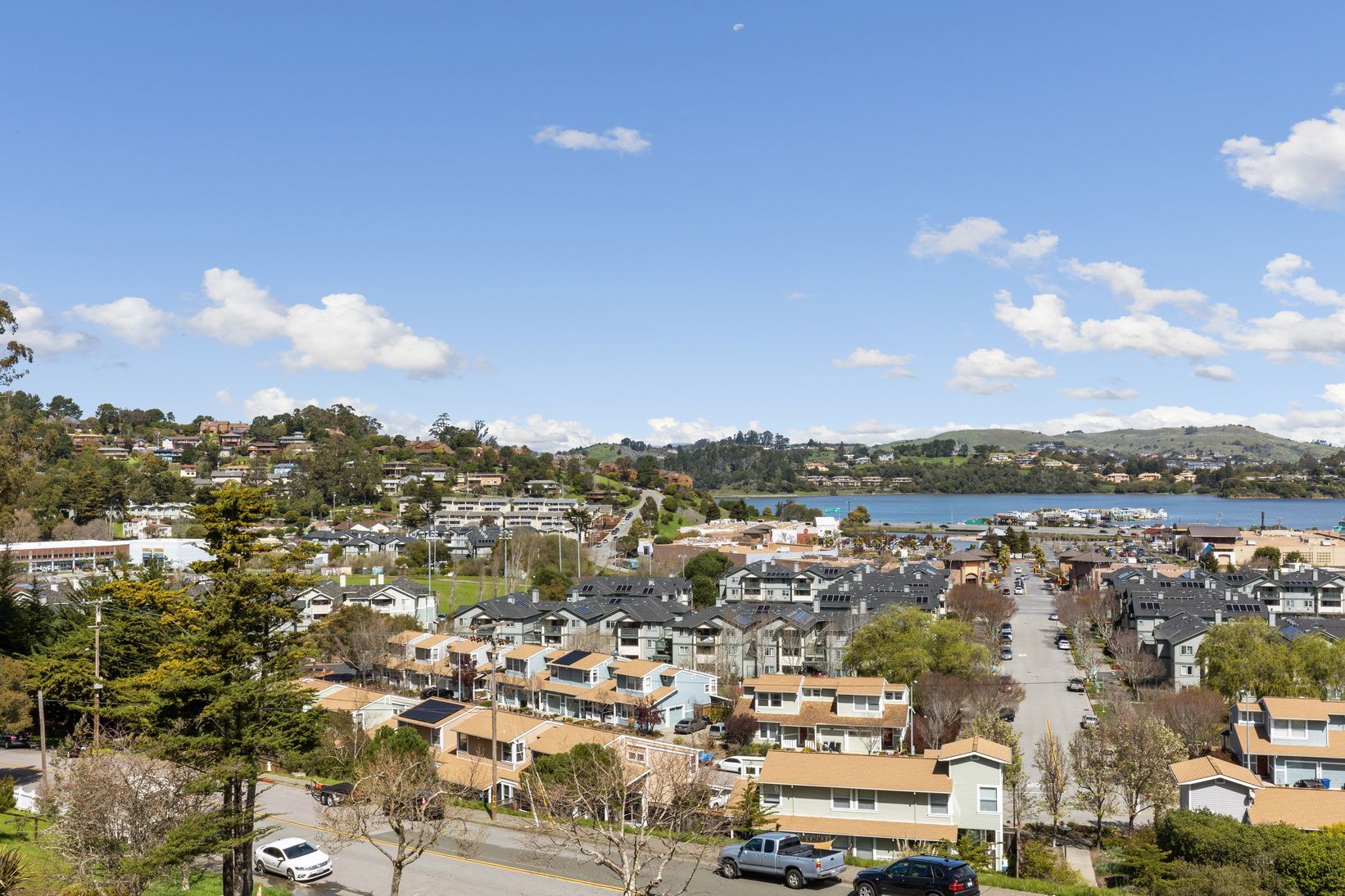 An aerial view of a residential area with a lake in the background.