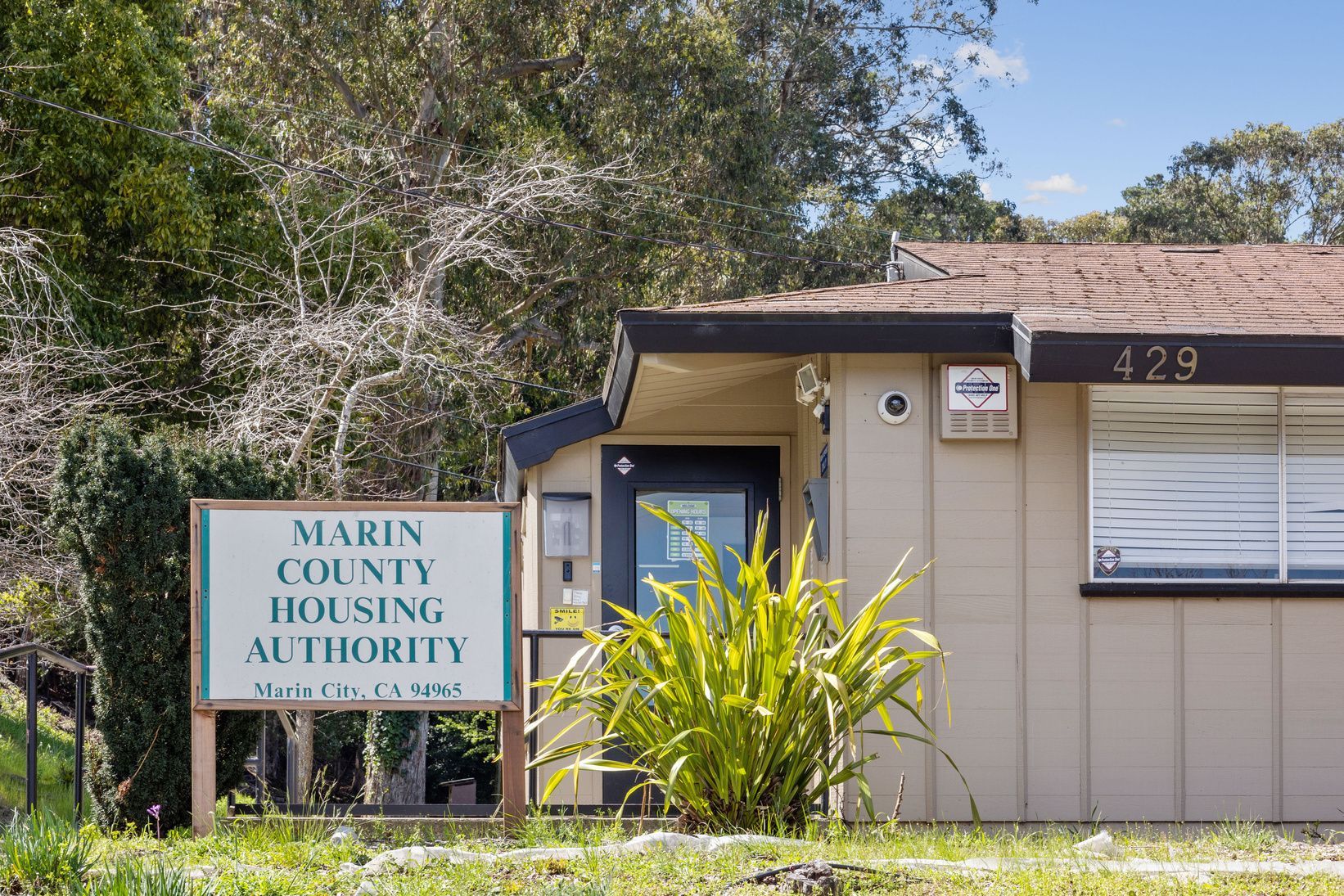 A house with a sign in front of it that says marin county housing authority.